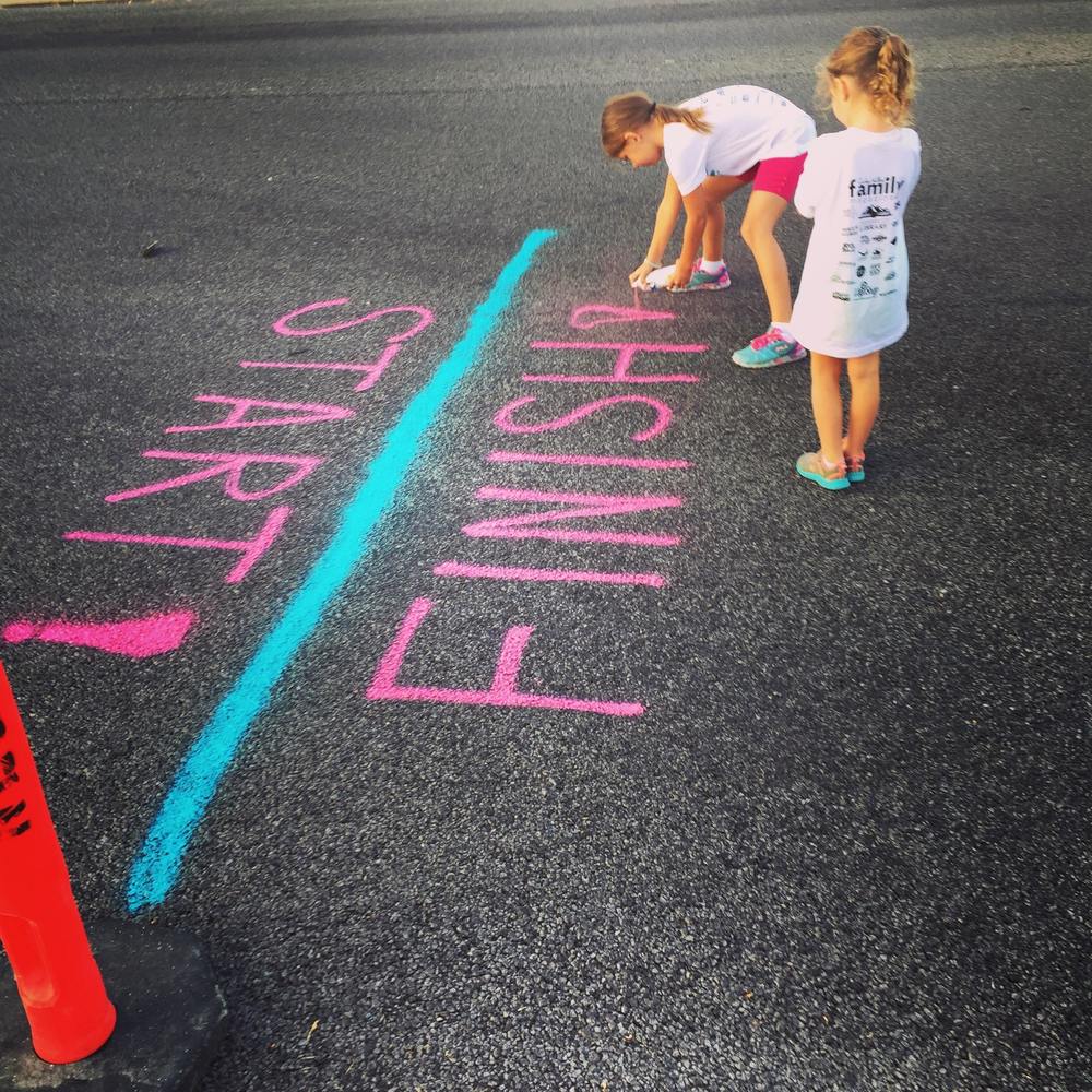 Girls painting a finish line